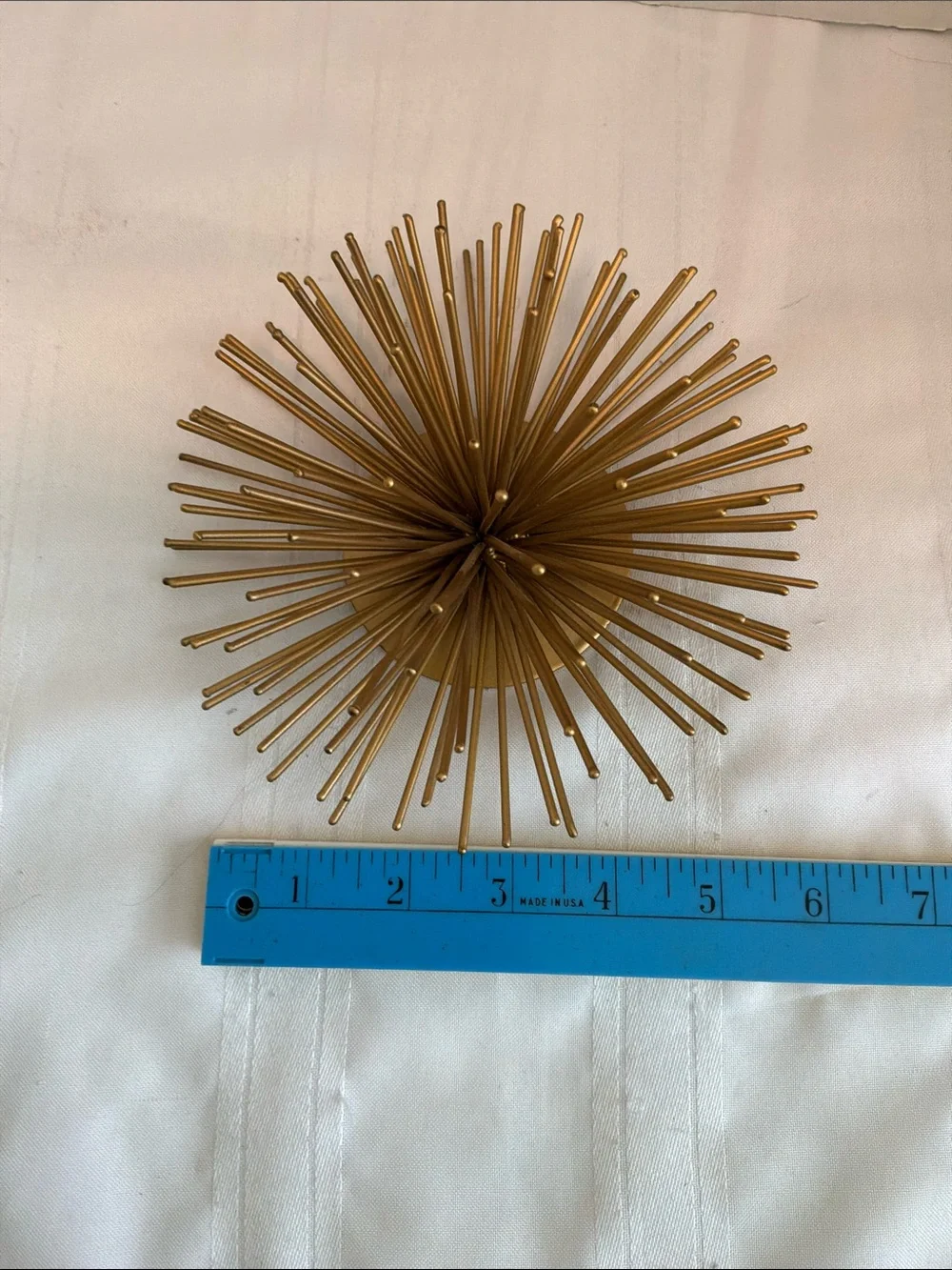 Gold tone metal atomic starburst or sea urchin wall art
